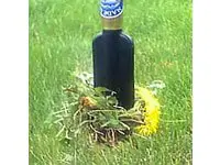 Dandelions wrapped around a bottle.