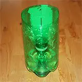 A soda bottle cut in half and filled with juice with the top inverted and placed inside to create a homemade fruit fly trap.
