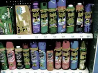 Various insecticide sprays on a shelf.