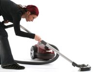 A woman vacuuming.